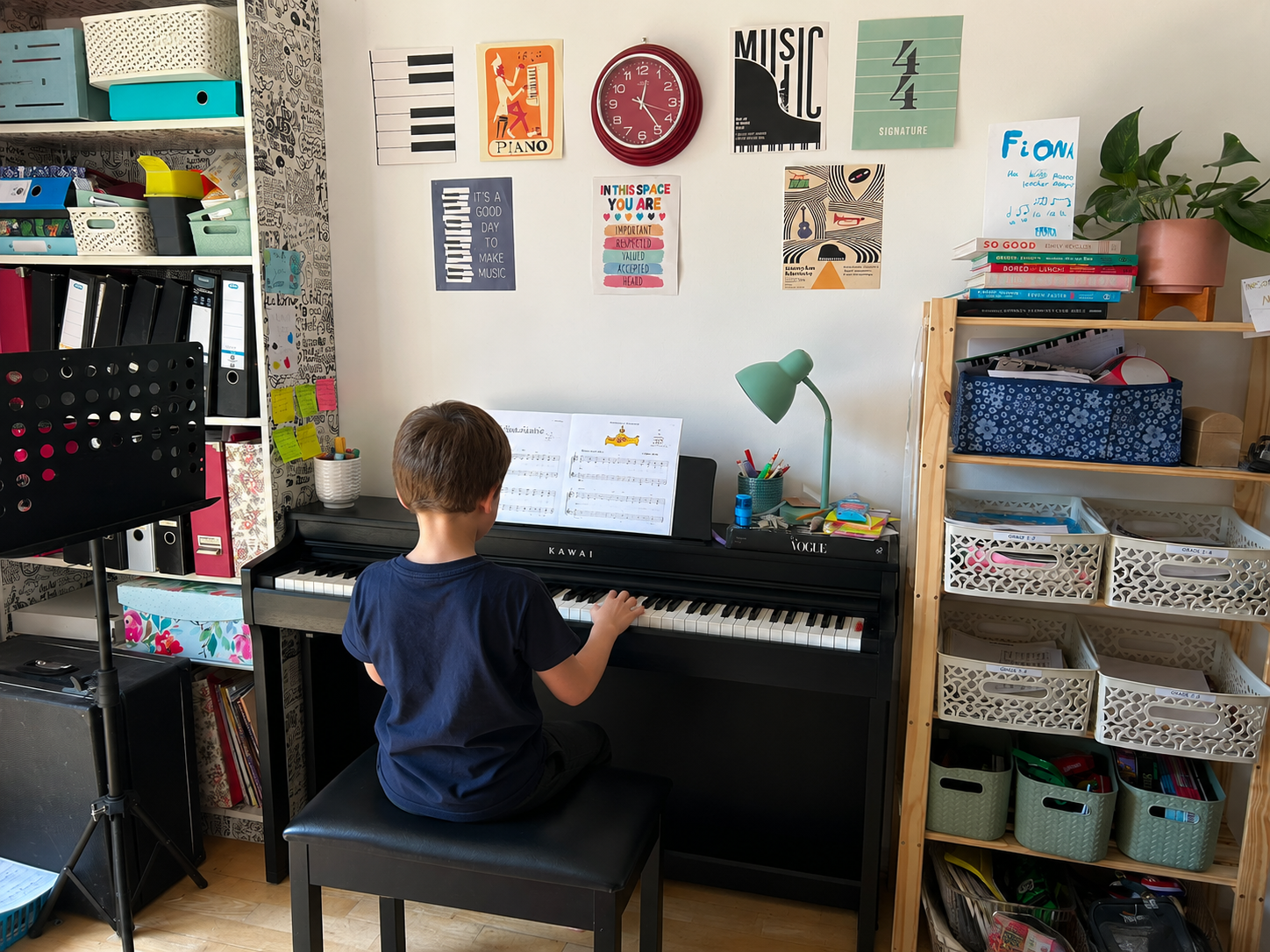 Fiona teaching a young child at the piano